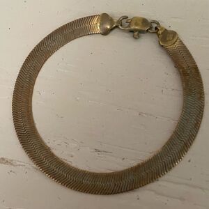 7.75” x 0.25" wide gold tone herringbone bracelet WTH lobster clasp